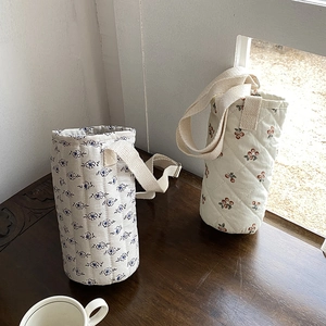 Quilted floral cotton water bottle carrier with adjustable shoulder strap and cherry pattern