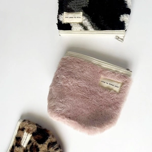 Detailed view of plush storage pouches in pink, leopard print, and cow print patterns