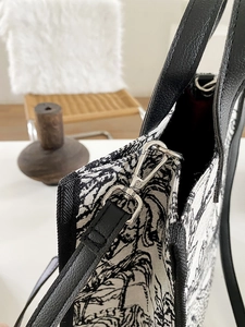 Détail latéral du sac en toile avec imprimé jungle vintage et bandoulière en cuir