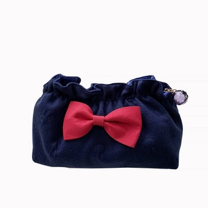 Navy blue waffle knit bow makeup bag with red satin ribbon and crystal zipper pull