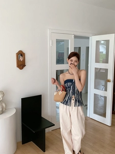 Detalle de un bolso de paja tejido arcoíris con borlas de colores para niñas pequeñas