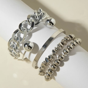 Silver bead bracelet and chunky Cuban chain stacking set displayed on white pedestal