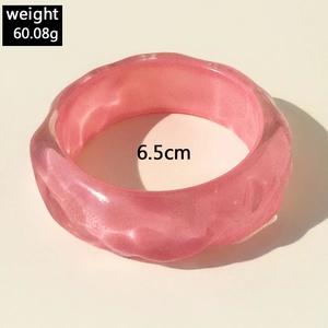 Detail showing pink resin bangle with wave texture including 6.5cm diameter size info