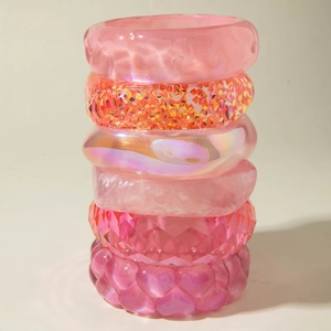 Pink resin bangle set with glitter hearts and marble texture in six different minimalist designs