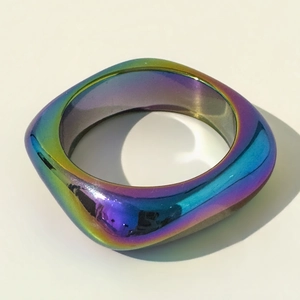 Close-up of geometric square resin bangle with iridescent laser finish and polished surface