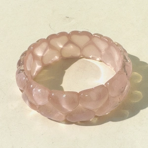 Close-up of pink heart-shaped link bracelet in translucent glitter resin material