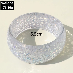 Macro shot of 6.5cm diameter colorful resin bracelet with holographic glitter and sequins