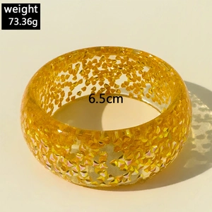 Detail of wide resin bangle with gold glitter flakes and 6.5cm diameter inner size