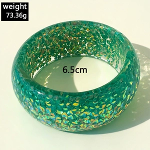 Detail view of a chunky green resin bracelet with colorful glitter and 6.5cm inner diameter