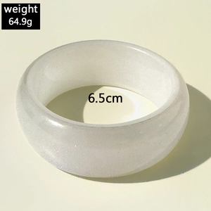 Détail d'un bracelet en résine blanche à texture marbrée, 6,5cm de diamètre et 64,9g de poids