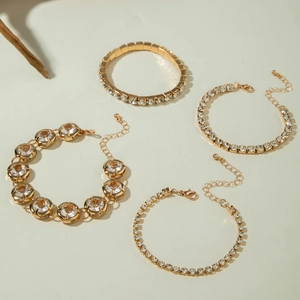 Macro shot of 4-piece gold CCB bracelet set with sparkling rhinestone inlay and link chain