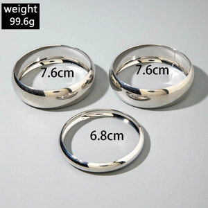 Detailed view of silver minimalist bangle set with dimensions 7.6cm and 6.8cm in diameter