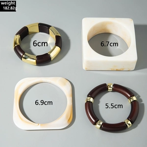 Detail view of four chunky resin bangles with marble textures and size specifications