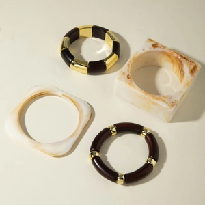 Chunky irregular resin bead bracelets and amber marble bangles set in retro style