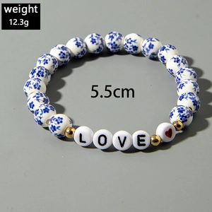 Detail of blue and white ceramic beads with LOVE letters and heart charm bracelet