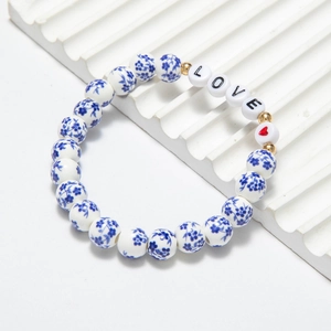 Detail of beaded bracelet with blue floral ceramic beads and LOVE letter charms