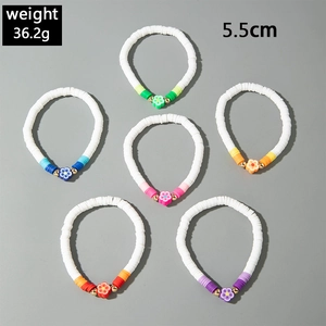 Set of six colorful heishi clay bead bracelets with flower charms and gold accents