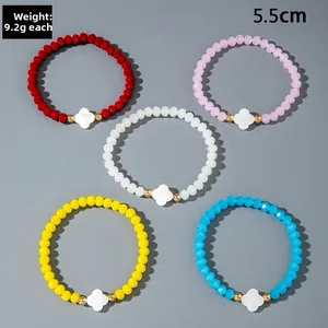 Detail of five-piece colorful crystal bead bracelets with white clover shell pendants