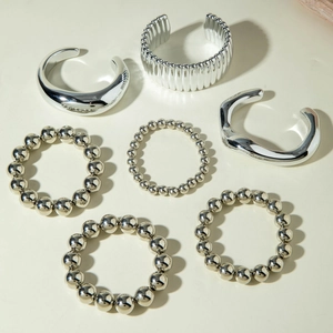 Detail of 6pcs silver beaded bracelets and chunky textured open bangles set