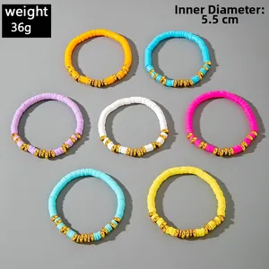 Macro detail of 7-piece colorful bohemian heishi beaded elastic bracelets with gold spacers