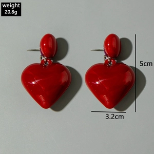 Detail view of red heart earrings with 5cm height and 3.2cm width dimensions