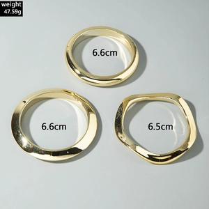 Three-piece set of gold-plated minimalist wide bangles with wavy and round designs