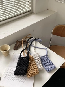 Four colors of handmade macrame phone bags with mesh hollow weave and long straps