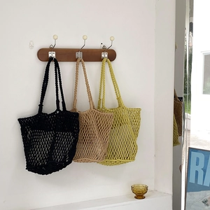 Details of handmade hollow woven tote bags in black, khaki, and lime green colors
