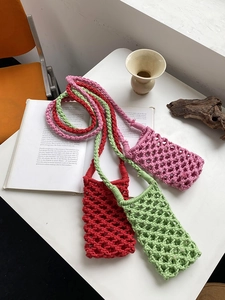 Detailed weave pattern of handmade cotton rope mobile bags in red, pink, and green