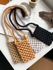 Detail view of handmade woven cotton rope phone bags in four earthy colors on white display
