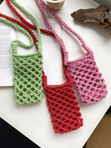 Three handmade woven crossbody phone bags in green red and purple with cotton rope mesh