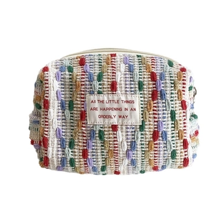 Large multi-color woven makeup bag with an orderly quote label for storage