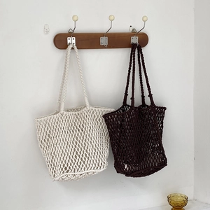 Handmade woven tote bags in cream and dark coffee colors for casual beach vacations