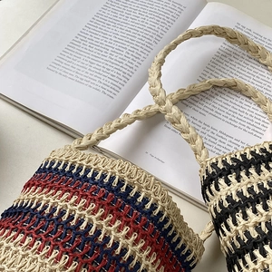 Handcrafted striped straw bucket bag with rope handles for summer beach holidays
