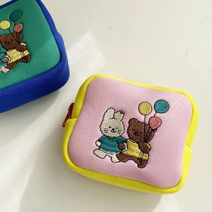 Close-up of cute cartoon embroidery on a pink square mini storage bag for small items