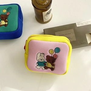 Detail of small canvas coin purses with cute bunny embroidery and mesh fabric panels