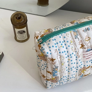 Detailed view of the quilted cotton pouch with star and cartoon elephant patterns