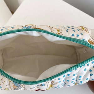 Quilted cotton makeup bag with Winnie the Pooh cartoon print and green zipper closure