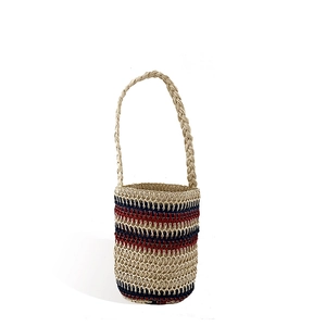 Handmade striped straw bucket bag with woven shoulder strap for summer beach vacations