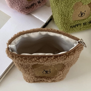 Detail of plush teddy fleece bear makeup bags with metal ring zippers and happy bear embroidery