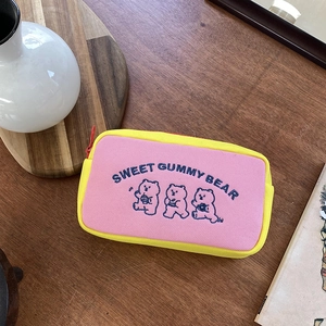 Close-up of cute gummy bear embroidery and high-quality canvas fabric on the storage bag