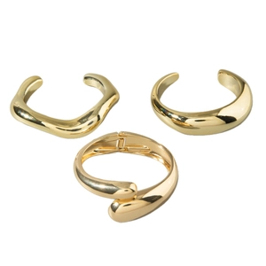 Three-piece set of minimalist geometric gold metal bracelets with polished mirror finish