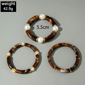 Detailed view of acrylic beaded bracelet set with marble texture and pearl accents