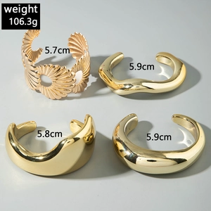 Set of four gold punk-style hollow cuffs and wave bracelets with dimensions and weight info