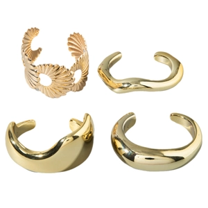 Set of four gold punk-style geometric hollow bangles in glossy CCB metallic finish
