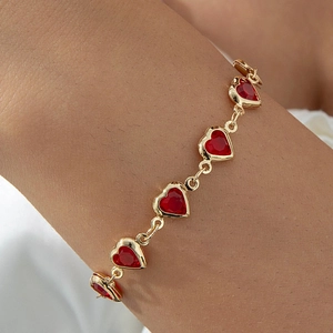 Elegant 18K gold plated bracelet with five brilliant red heart-shaped crystals