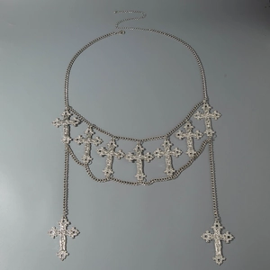 Detail of silver punk waist chain featuring gothic metal cross charms and lobster clasp