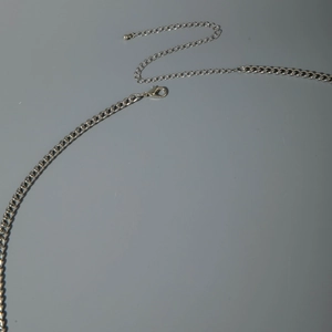 Close-up of punk style silver metal waist chain with lobster clasp and adjustable extension