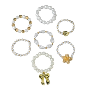 7-piece set of layered pearl bracelets with gold heart, flower and bow pendants