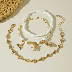 Bohemian 3-piece beaded anklet set with gold starfish shell charms for beach vacations